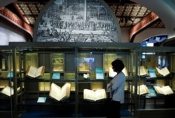 FILE - A visitor looks at various Bibles during a preview at the Museum of the Bible in Washington, D.C., Nov. 14, 2017.