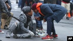 FILE - Will Smith, right, films a scene in "Collateral Beauty," set in New York City, March 31, 2016.