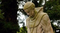 A statue of Father Junipero Serra stands in the cemetery of Mission Dolores in San Francisco.