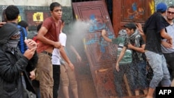 Egyptian students of al-Azhar University block the access to an administrative building during an anti-army protest in Cairo October 30, 2013.