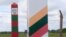 Lithuanian (R) and Russian border signs are seen near the Sudargas border crossing point with Russia in Ramoniskiai, Lithuania, June 5, 2017.