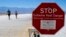 FILE - A sign warns people of extreme heat in multiple languages on Tuesday, July 11, 2023, in Death Valley National Park, Calif. July is the hottest month at the park with an average high of 116 degrees (46.5 Celsius).