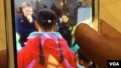 At a mall in Dresden, Germany, a man holds up a picture of the time he reported being attacked by locals, angry at the large influx of refugees and migrants. Since then he has been attacked again twice, but hasn't reported, July 8, 2016. (Photo: H. Murdo