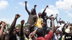 Protesters chant solidarity songs as they block the Lagos-Ibadan expressway, railing against police brutality and the killing of protesters by the military, at Magboro, Ogun state, Nigeria, Oct. 21, 2020. 