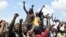 Protesters chant solidarity songs as they block the Lagos-Ibadan expressway, railing against police brutality and the killing of protesters by the military, at Magboro, Ogun state, Nigeria, Oct. 21, 2020. 