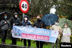 People demonstrate outside Pazo de Meiras, former Spanish dictator Francisco Franco's summer palace, which is being handed over by Franco's heirs to the Spanish state in Sada, northwestern Spain, Dec. 10, 2020.