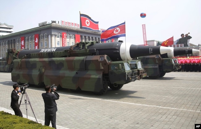 FILE - In this April 15, 2017, file photo, what analysts believe could be the North Korean Hwasong 12 is paraded across Kim Il Sung Square during a military parade in Pyongyang, North Korea. (AP Photo/Wong Maye-E, File)