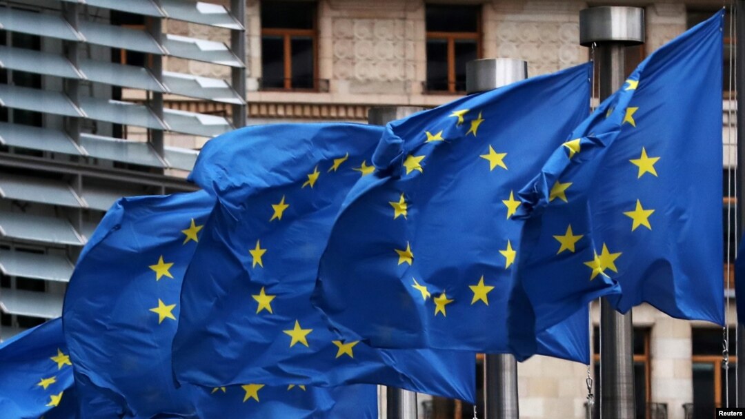 FILE - An EU flag flutters in the wind.