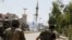 Syrian army soldiers run after a bomb exploded on a street in the town of Douma near Damascus, May 20, 2012.