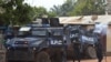 Armed Congolese soldiers get out of their vehicles after a Congolese armored vehicle of the UPC Congo