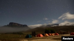 Mt. Kukenan (L) and Mt. Roraima are seen from the Tec Camp, near Venezuela's border with Brazil, Jan. 14, 2015.