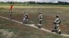 FILE - Indian Border Security Force soldiers walk across the open border with Bangladesh to attend a flag meeting in West Bengal, India, June 20, 2015. Indian officials said Sept. 23, 2017, that because of security risks, border forces have been authorized to prevent Rohingya Muslims from entering the country.