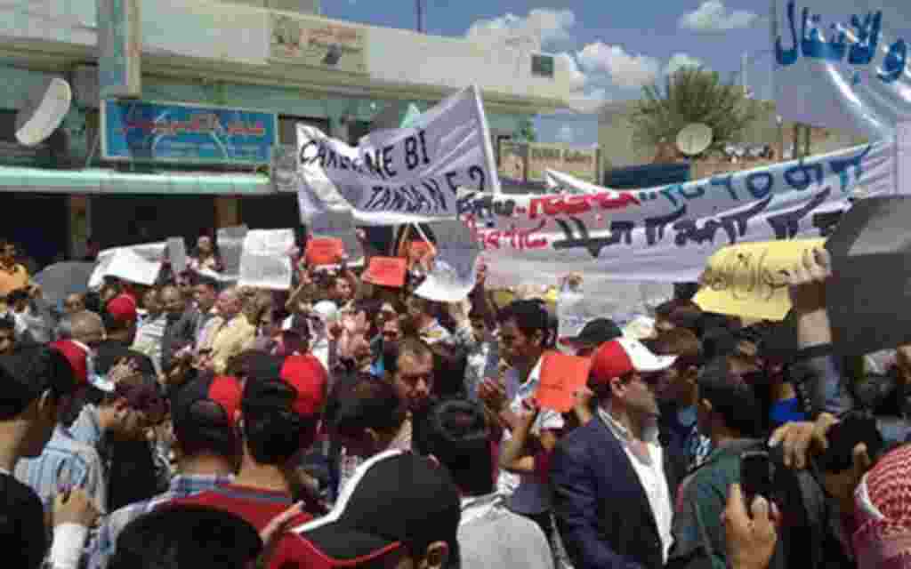 Syrian anti-regime protesters march during a rally in the northeastern Syrian Kurdish town of Qamishli as regime opponents took to the streets for rallies which President Bashar al-Assad ordered troops not to fire on, even as his forces mounted a sweeping