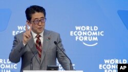 Japanese Prime Minister Shinzo Abe addresses the annual meeting of the World Economic Forum in Davos, Switzerland, Jan. 23, 2019.