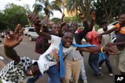 Zimbabweans celebrate in Harare, Nov, 21, 2017, after the resignation of President Robert Mugabe.