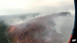 FILE - This image made from video provided by RU-RTR Russian television channel shows a view of a forest fire in the Boguchansky district of the Krasnoyarsk region, Russia Far East, July 31, 2019. 