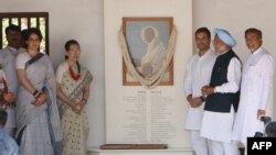 Indian Congress President Rahul Gandhi (3R), former Indian PM Manmohan Singh (2R), Congress Party Chairperson Sonia Gandhi (3L) and All India Congress Committee gen-sec for eastern Uttar Pradesh Priyanka Gandhi Vadra (2L) pose next next to a portrait of Gandhi, March 12, 2019. 