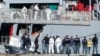 FILE - Migrants disembark from an Italian navy ship at the port of Shengjin, northwestern Albania, Nov. 8, 2024.