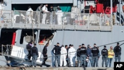 FILE - Migrants disembark from an Italian navy ship at the port of Shengjin, northwestern Albania, Nov. 8, 2024.