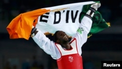 Cheikh Sallah Cisse of Ivory Coast celebrates after defeating Lutalo Muhammad of United Kingdom.