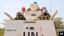 FILE - Highway attacks in South Sudan aren't a new issue. Here, U.N. peacekeepers lead a patrol from Bentiu toward Nhialdiu, part of an increase in patrols after an increase of reports of violent attacks on roads, Dec. 7, 2018.