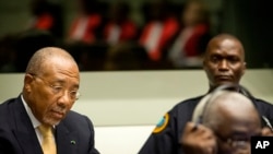 Former Liberian President Charles Taylor, left, waits for the start of his appeal judgement at the Special Court for Sierra Leone (SCSL) in Leidschendam, near The Hague, Netherlands, Sept. 26, 2013.