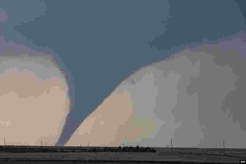 A tornado is seen South of Dodge City, Kansas, moving north of the city, May 24, 2016. About 30 tornadoes were reported in five different states from Michigan to Texas.