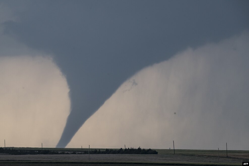 A tornado is seen South of Dodge City, Kansas, moving north of the city, May 24, 2016. About 30 tornadoes were reported in five different states from Michigan to Texas.
