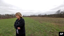 In this April 12, 2016 photo, Desiree Moninski, walks on land located across from her house in Dudley, Mass., which is the site of a proposed Muslim cemetery, a project vigorously opposed by area residents. Regarding the land once farmed by her grandparents, Moninski said she and other opponents have legitimate concerns that have nothing to do with Islam.