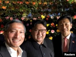 Singapore's Foreign Minister Vivian Balakrishnan, North Korean leader Kim Jong Un, and Singapore's Education Minister Ong Ye Kung pose for a photo in Singapore, June 11, 2018, in this photo obtained from social media.