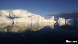 Icebergs are reflected in the calm waters at the mouth of the Jakobshavn ice fjord near Ilulissat in Greenland. (file photo)