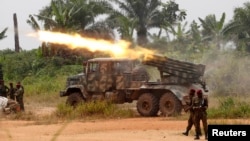 FILE - Democratic Republic of Congo soldiers launch missiles during a military operation against ADF rebels outside the town of Beni, in North Kivu province, Jan. 18, 2014.