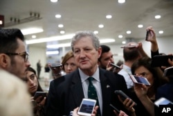 FILE - Sen. John Kennedy, R-La., responds to a reporter's question on Capitol Hill, Oct. 3, 2018 in Washington.