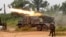 FILE - Democratic Republic of Congo soldiers launch missiles during a military operation against ADF rebels outside the town of Beni, in North Kivu province, Jan. 18, 2014.