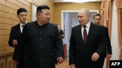 North Korean leader Kim Jong Un walks with Russian President Vladimir Putin shortly after Putin's arrival in Pyongyang, early on June 19, 2024.