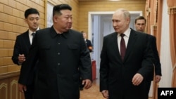 러시아 국영 스푸트니크 통신이 배포한 이 사진에서 김정은 북한 국무위원장(왼쪽)이 19일 평양에 도착한 블라디미르 푸틴 러시아 대통령과 함께 걷고 있다. 