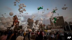 People release scores of white balloons bearing the names of the Aug. 4 blast victims at about 6:07 p.m., when the deadly explosion occurred, to mark the two-month anniversary, next to the seaport of Beirut, Lebanon, Sunday, Oct. 4, 2020. 