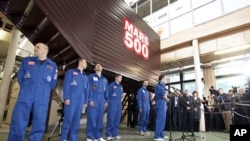 Mars500 experiment crew members talk to journalists after leaving the mock spaceship in Moscow, November 4, 2011