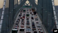 FILE - Vehicles make their way westbound on Interstate 80 across the San Francisco-Oakland Bay Bridge as seen from Treasure Island in San Francisco, Dec. 10, 2015. 