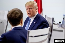 French President Emmanuel Macron and President Donald Trump participate in a G-7 Working Session on the Global Economy, Foreign Policy, and Security Affairs the G-7 summit in Biarritz, France August 25, 2019.