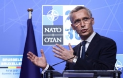FILE - NATO Secretary General Jens Stoltenberg speaks during a media conference at a NATO summit in Brussels, June 14, 2021.