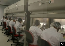 Sanaria staff produces the PfSPZ vaccine in the company's clinical manufacturing facility.