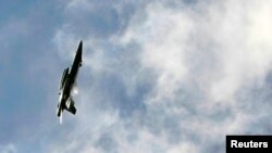 FILE - An Australian FA-18 fighter aircraft circles over Sydney.