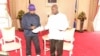 Kanye West autographs sneakers to Uganda President Yoweri Museni in State House Entebbe, Oct. 15, 2018.