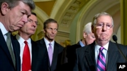 From left, Sen. Roy Blunt, R-Mo., Sen. John Barrasso, R-Wyo., Sen. John Thune, R-S.D., Senate Minority Whip John Cornyn of Texas, and Senate Minority Leader Mitch McConnell R-Ky., pause during a news conference on Capitol Hill in Washington, Nov. 18, 2014