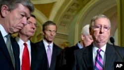 From left, Sen. Roy Blunt, R-Mo., Sen. John Barrasso, R-Wyo., Sen. John Thune, R-S.D., Senate Minority Whip John Cornyn of Texas, and Senate Minority Leader Mitch McConnell R-Ky., pause during a news conference on Capitol Hill in Washington, Nov. 18, 2014