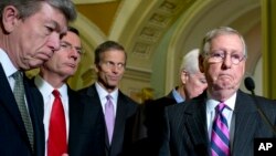 From left, Sen. Roy Blunt, R-Mo., Sen. John Barrasso, R-Wyo., Sen. John Thune, R-S.D., Senate Minority Whip John Cornyn of Texas, and Senate Minority Leader Mitch McConnell R-Ky., pause during a news conference on Capitol Hill in Washington, Nov. 18, 2014