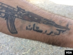 A man shows his tattoo that reads "Kurdistan" and says he, like other Kurds, still dream of an independent state on Oct. 17, 2017. (H.Murdock/VOA)