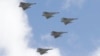FILE - Taiwan's Mirage 2000 fighter jets fly in close formation over President Office during National Day celebrations in front of the Presidential Building in Taipei, Oct. 10, 2021.