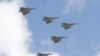 FILE - Taiwan's Mirage 2000 fighter jets fly in close formation over President Office during National Day celebrations in front of the Presidential Building in Taipei, Oct. 10, 2021.